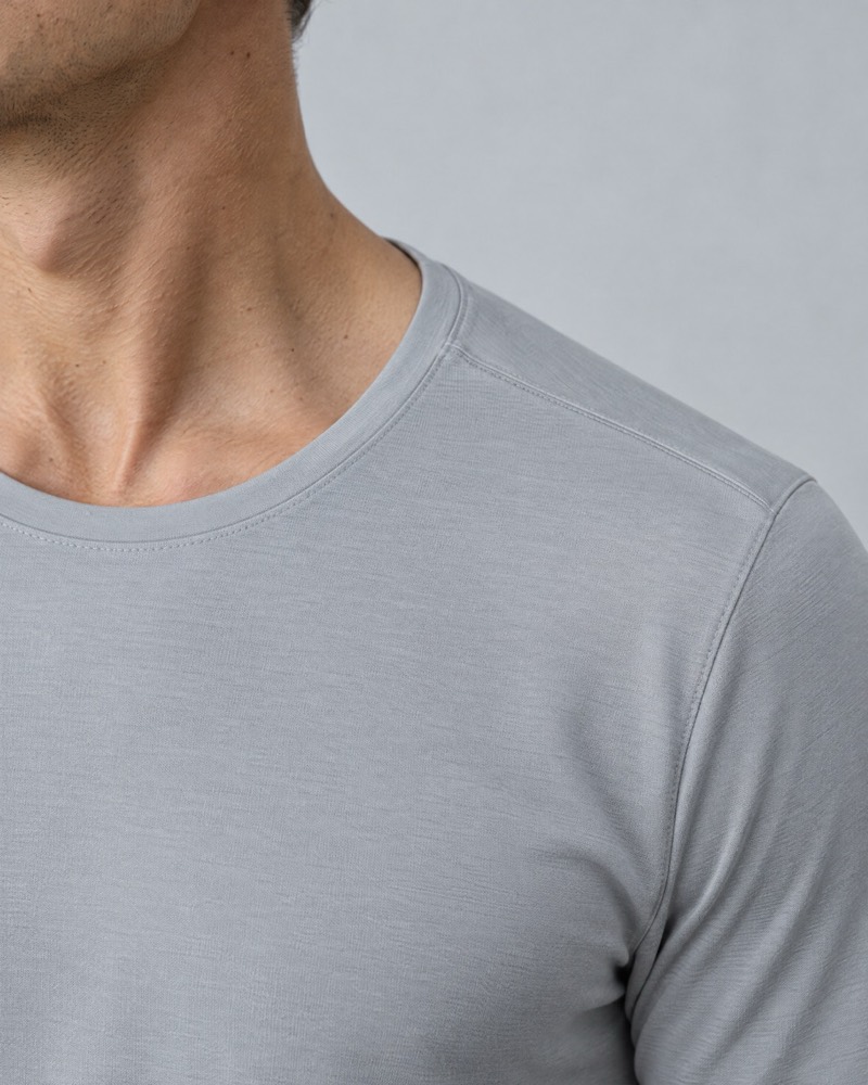 Silver smooth-knit training tee at the shoulder and collarbone